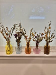 dried flowers in decorative jars